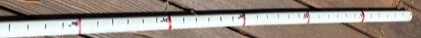 PVC measuring stick marked with tape at six-inch increments
